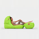 Coolio Wild Lime green beanbag sofa and matching footrest with a woman reclining
